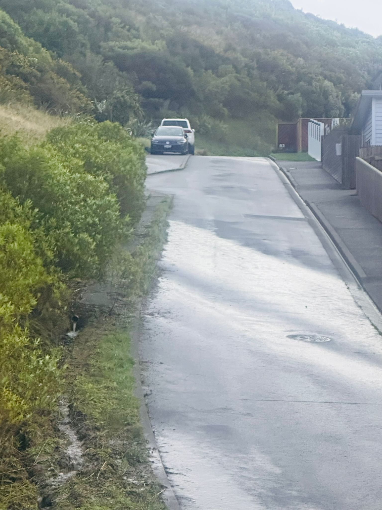 Water sheeting down the accessway from a pipe outlet